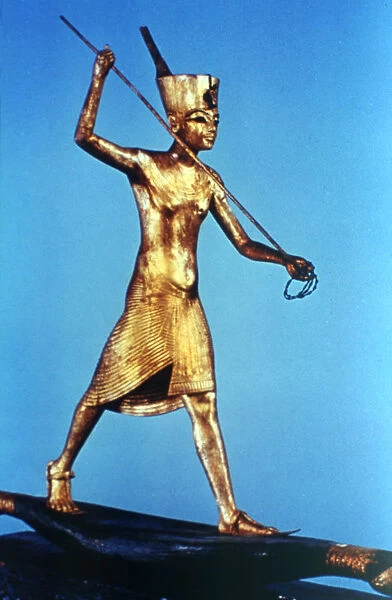Gold figure of King Tutankhamun standing on a reed boat and spearing fish, 14th century BC