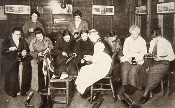 A group of women receive a lesson in boot repairing, World War I, c1914-c1918. Artist