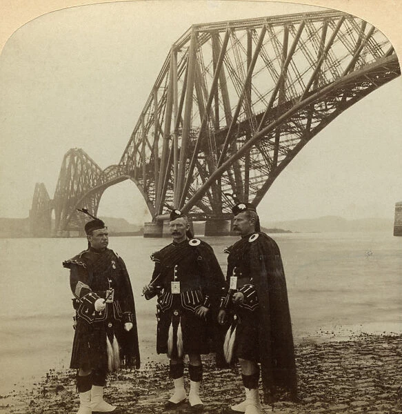 Men in Highland dress in front of the Forth Bridge, Scotland. Artist: Underwood & Underwood