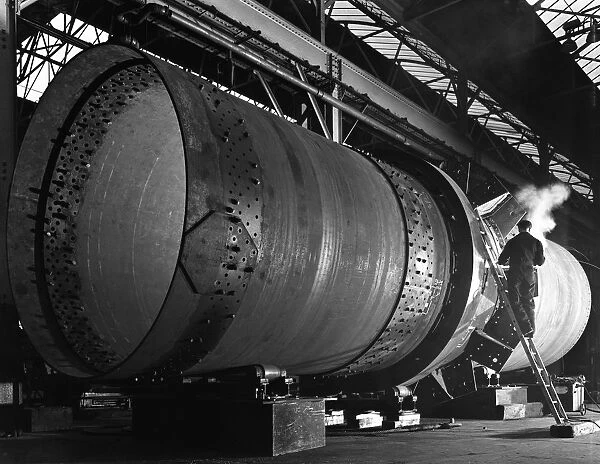 A rotary kiln section being welded in preparation for installation, Steetley, Nottinghamshire, 1962