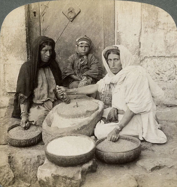 Women grinding at the mill, Palestine, 1900. Artist: Underwood & Underwood