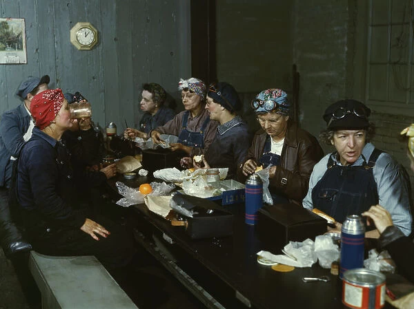 Women workers employed as wipers in the roundhouse having lunch... C&NWRR. Clinton, Iowa, 1943. Creator: Jack Delano