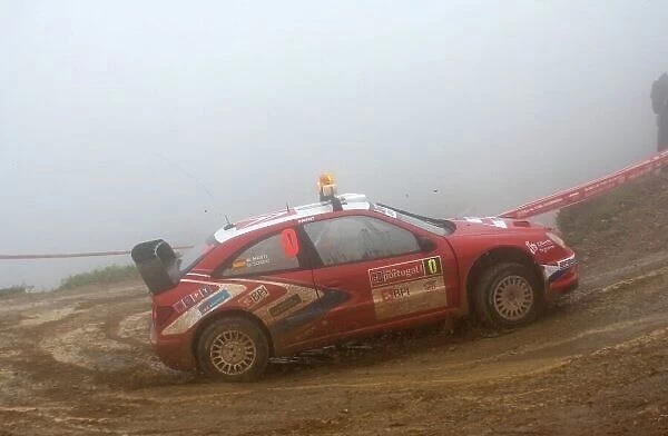 F5585. Daniel Sordo (ESP) negotiates a hairpin on a very rainy and foggy stage 1.