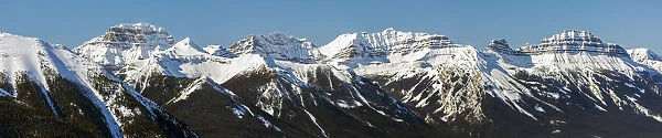 Panorama of snow-covered mountain range and blue sky