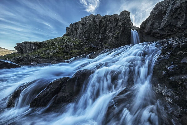 A Small Waterfall Flows Into The Ocean Along The Eastern Coast Of Iceland; Iceland