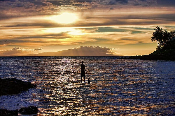 Stand-up Paddle boarder at sunset