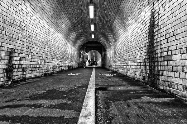 White Line Down The Middle Of A Dirty, Worn Pedestrian And Cycling Tunnel; York, Yorkshire, England