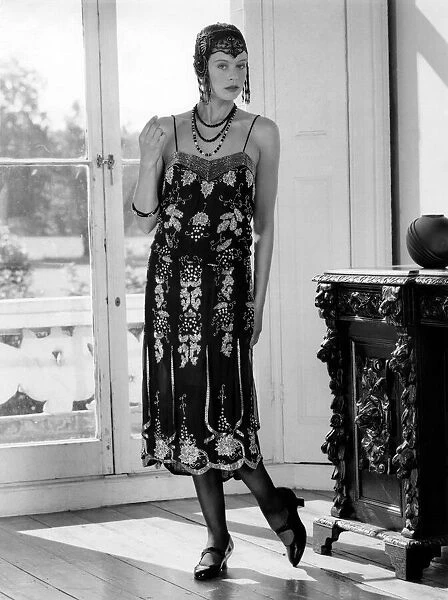 1920s fashions: Beaded flapper dress and skull cap with neat T-bar shoes