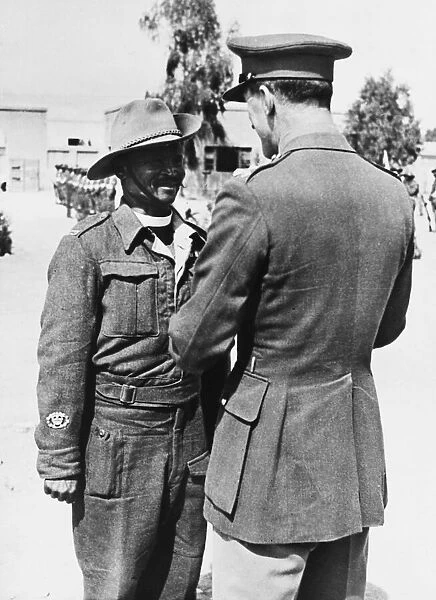 A British Brigadier pins the Africa Star on the breast of an Eswatini padre