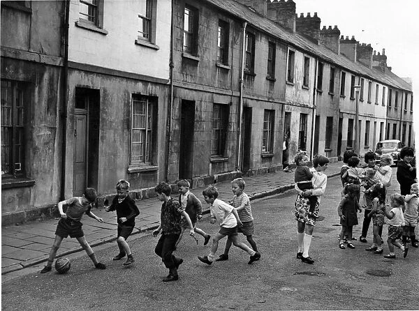 Children playing football in the street at Sandon Place, in Adamsdown