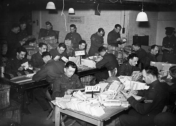 Clerks at work in an Army Post Office dealing with letters