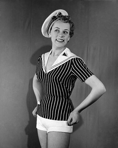Clothing Beachwear. Model wears sailors hat, striped fitted naval style top
