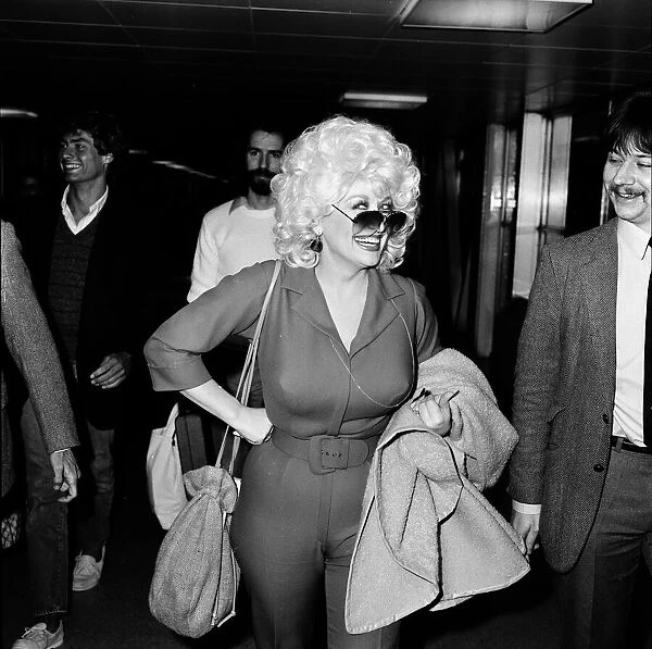 Country & Western singer Dolly Parton arrving at London Airport. 22nd March 1983