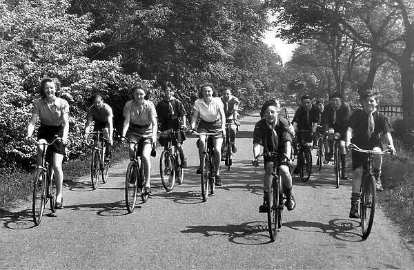 Cyclists out for a spin along a country lane near Belsay in Northumberland in 1950