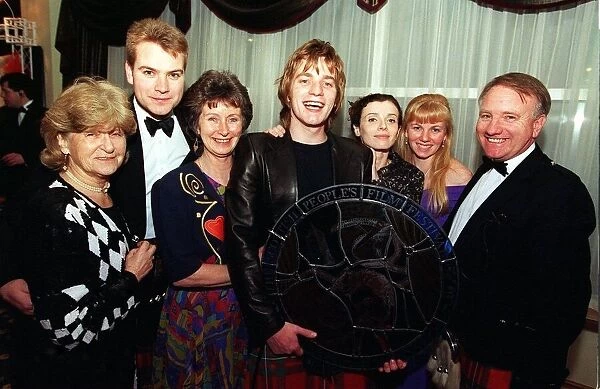 Ewan McGregor with his award and family members. L-R Phyllis Lawson (Gran
