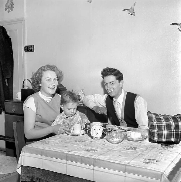 Family life: Mr. and Mrs. Hull giving their son his tea. 1954 A160-002