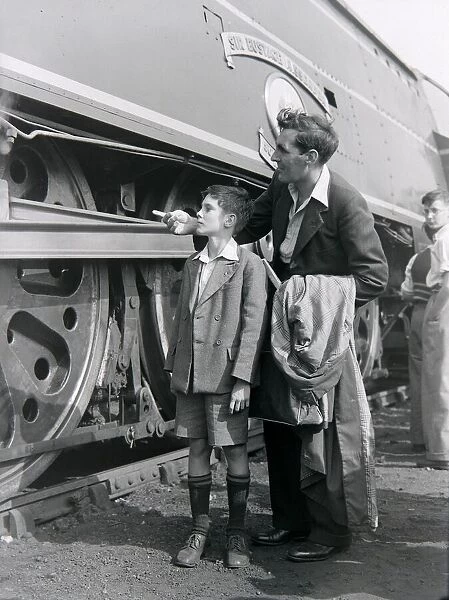 A father and son admire the steam locomotive during an open day at the Ashford railway