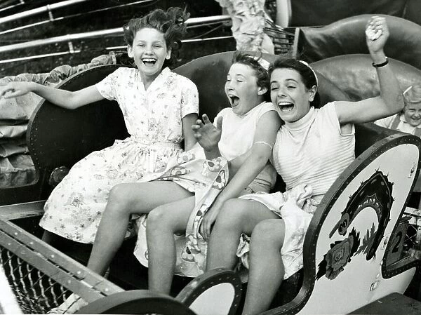 Three girls riding the Caterpillar at Margates Dreamland fun fair
