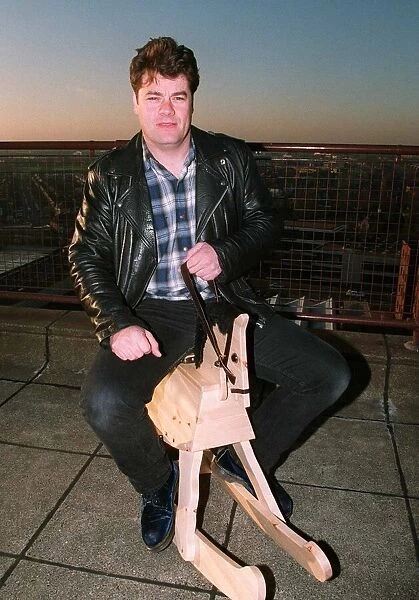 Gordon Kennedy TV Presenter of the National Lottery - sitting on a rocking horse