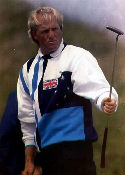 Greg Norman golfer holding putter golf club wearing sweater with Australian flag