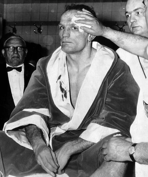 Henry Cooper having his wounds attended to in dressing room May 1966 after the World