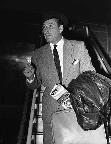 Hollywood star Errol Flynn seen here arriving at London Airport 17th November 1953