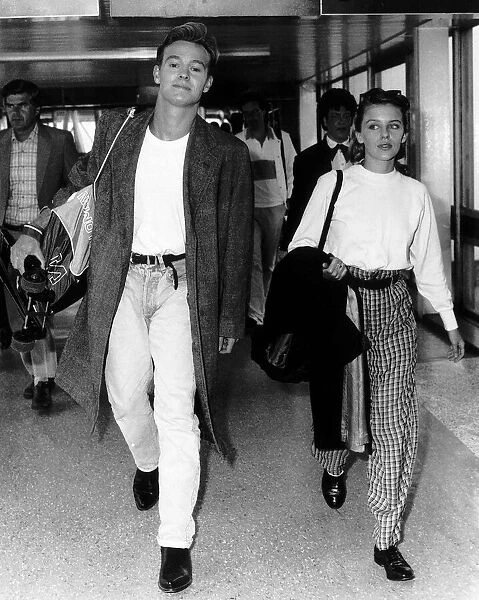 Jason Donovan actor singer with Kylie Minogue actress singer walk through airport