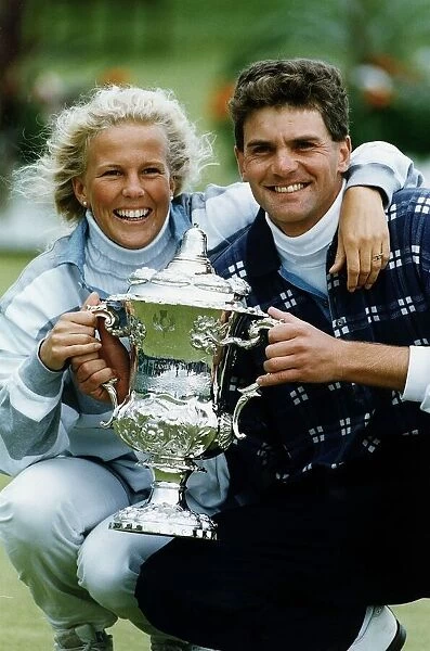 Jesper Parnevik and unidentified woman holding up trophy golf