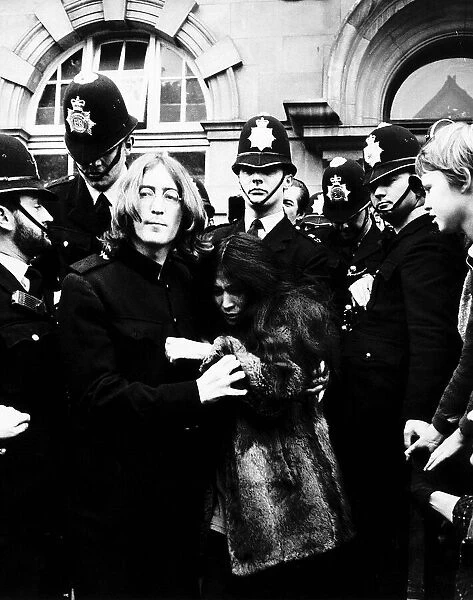 John Lennon Beatles Singer with wife Yoko Ono surrounded by police