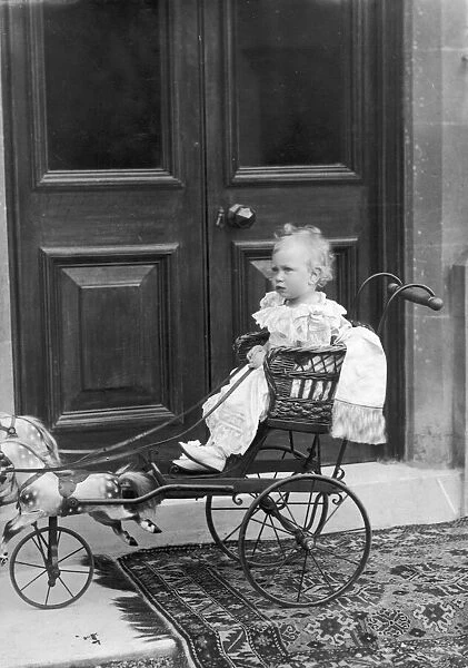 KIng George VI as a child enjoying a ride in a horse and buggy
