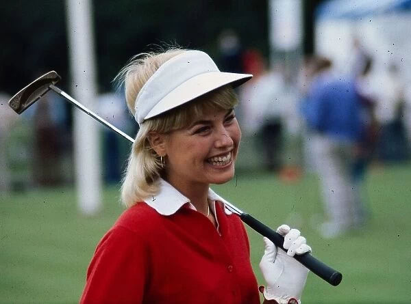 Laura Baugh golfer August 1977 Whgite skip hat red jumper golf club