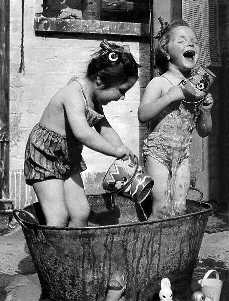 Linda Knott (left) and Mavis Vallance, both aged 3, enjoy a splash around in Mavis