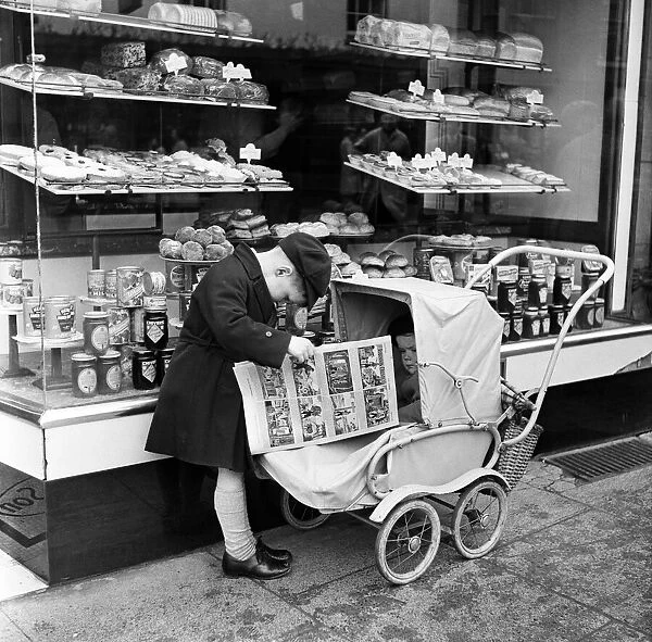 Little boy waits for his mother outside the Bakers shop in Stratford-upon-Avon