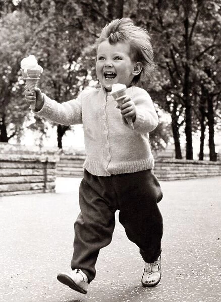 Little girl enjoying ice cream. Circa 1950