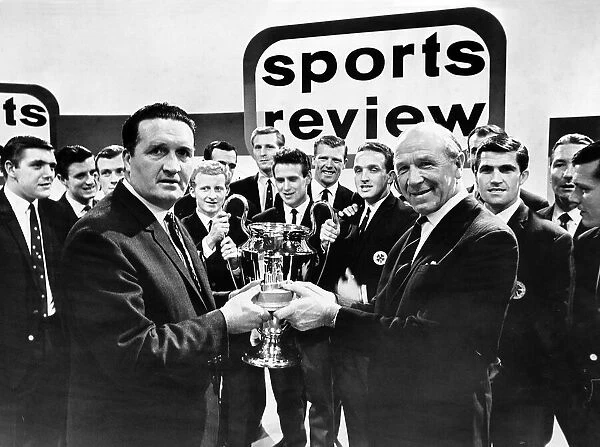 Manchester United football manager Matt Busby handing the Team of the Year Trophy to