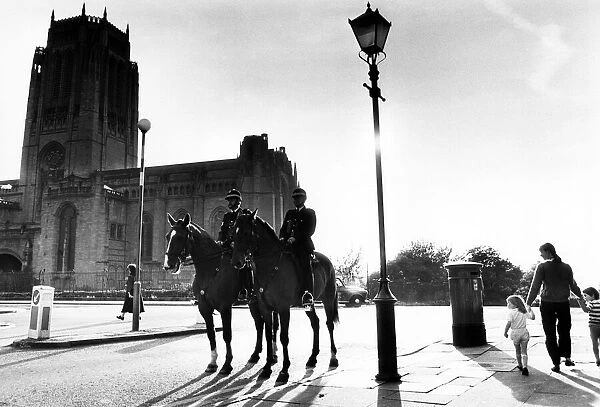 Police mounted on horses patrol the area around Liverpool Anglican Cathedral