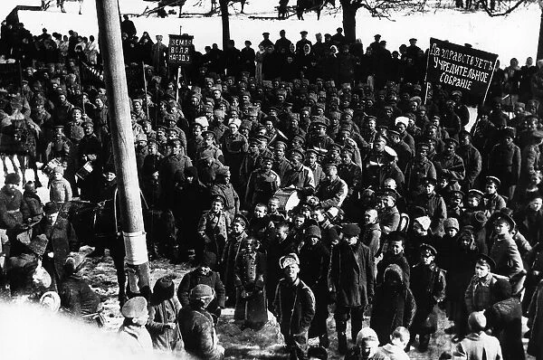 Russian Soldiers and workers listen to loudspeakers in 1917 at the graveside of