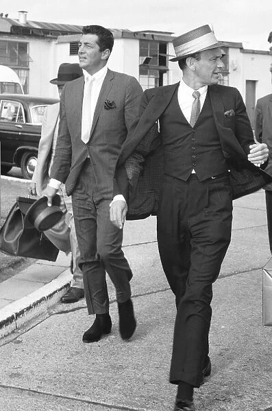 Singers Frank Sinatra and Dean Martin seen here at Heathrow Airport shortly after their
