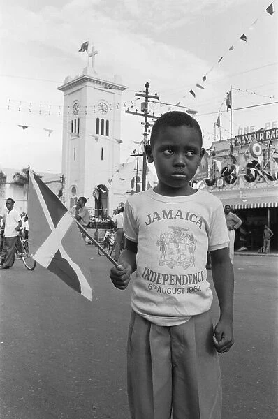 Small boy on the streets of Kingston less than impressed with the celebrations of