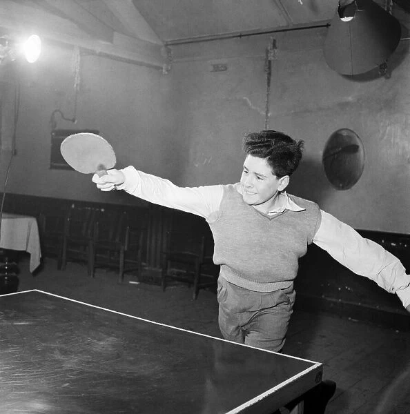 Young boy playing table tennis. January 1953 D232