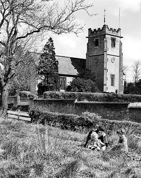 A young family enjoy a summers day in 1950, near Wylams Parish Church