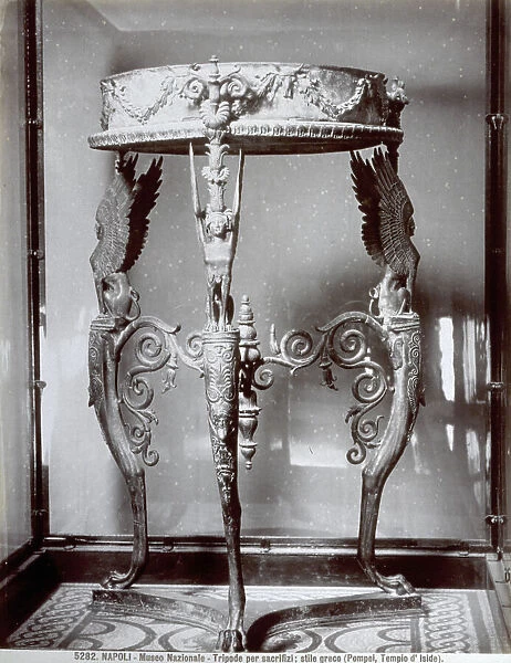 The picture shows a bronze tripod from the Temple of Isis in Pompeii, in the Museo Archeologico Nazionale in Naples