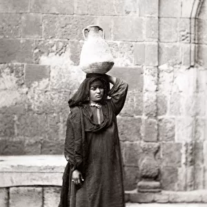 Arab peasant woman carrying water, Egypt, circa 1880. Date: circa 1880