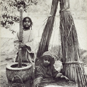 Boatmens Children - pounding rice - India