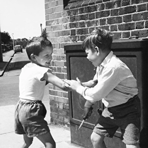Two boys having mock fight, Balham, SW London