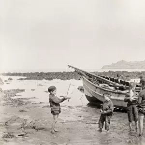 Children playing on the beach aat Runswick Bay Yorkshire