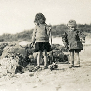 Two children with toys on a beach, Scotland
