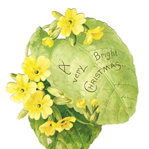 Christmas card in the shape of a green leaf with primroses