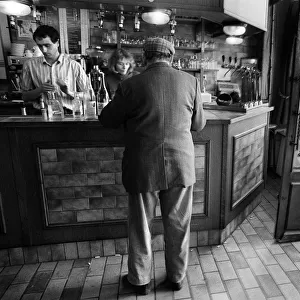 A customer is served in a bar in Luzarches, France