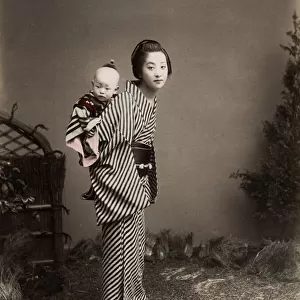 Japan - young nurse carrying a baby